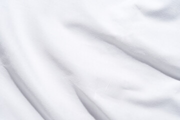 Smooth white fabric texture with soft light and subtle shadows for background or design.