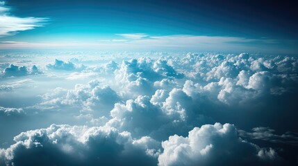 Aerial View of Lush White Clouds Illuminated by Soft Sunlight Against a Serene Blue Sky with Gradual Transition of Colors
