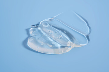 The texture of a cosmetic gel on a blue background.