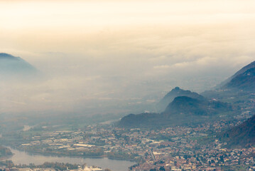 top view of the Como Lake from the Resinelli Piani in a foggy morning, Lecco province, Italy