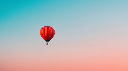 Obraz premium Hot air balloon flying high in clear sky at dawn. Metaphor for freedom, adventure, dreams