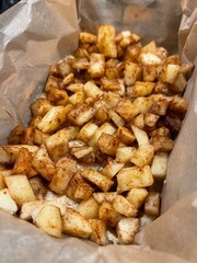 Close-up image of freshly diced apples coated in cinnamon, ideal for various baking recipes and desserts. The warm, sweet aroma of the cinnamon enhances the inviting appearance.