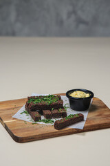 a simple yet delicious snack or appetizer, featuring the hearty texture and flavor of rye bread, the freshness of the herbs, and the creamy, tangy dipping sauce.