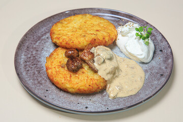 The combination of the crispy potato pancakes, the savory mushrooms, the creamy sauce, and the light whipped cream