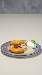 The combination of the crispy potato pancakes, the savory mushrooms, the creamy sauce, and the light whipped cream