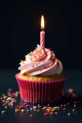 A single, richly frosted cupcake, adorned with vibrant sprinkles and a flickering candle, set against a deep black backdrop , photography, baking