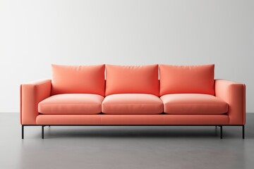 Fototapeta premium a close up of a couch with pillows on a gray floor