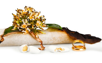 Partially burnt wedding certificate with wedding rings and sugared almonds representing the end of...