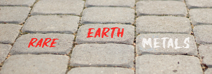 Rare earth metals symbol. Concept words Rare earth metals on beautiful grey road break. Beautiful...