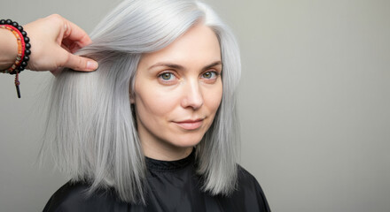 Fototapeta premium Caucasian adult female with gray hair, hair styling session, confident expression