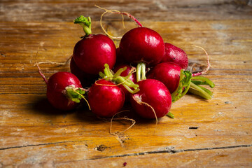 Top view of radishes on wooden table, horizontal with copy space