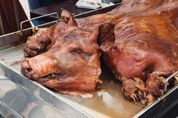 Traditional Ecuadorian Roast Pig “Chancho Hornado” at a Food Market. Whole roasted pig, known...
