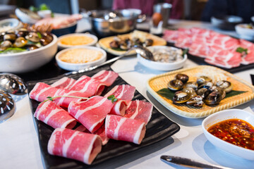 Various fresh hotpot ingredients in restaurant