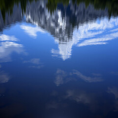 Reflection of Clouds and Trees in Water