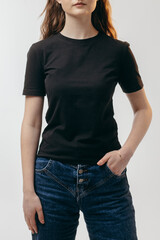 Obraz premium Stylish blonde girl wearing black t-shirt posing in studio