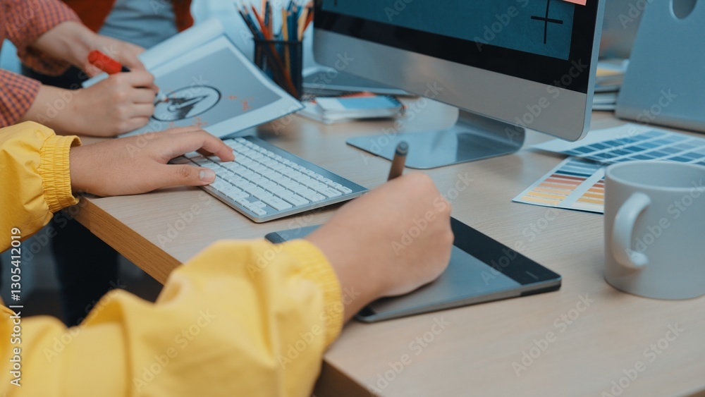 Poster engaging workspace image showing creative individuals using a drawing tablet and keyboard to craft a