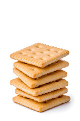 Stacked pile of crispy saltine crackers, isolated on white background