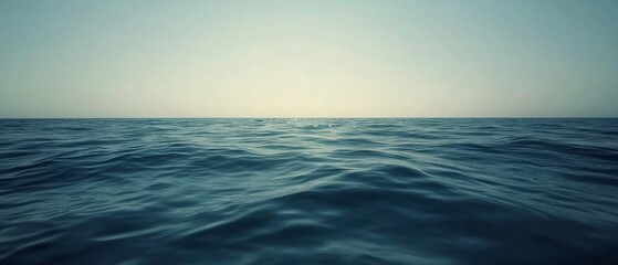 Obraz premium Vast ocean meets sky, creating an infinite horizon with gentle waves under a soft gradient of colors, evoking tranquility and boundlessness.
