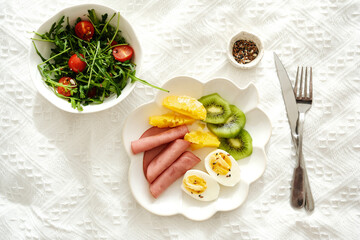 A nutritious and healthy breakfast plate artfully arranged with a variety of fruits and vegetables