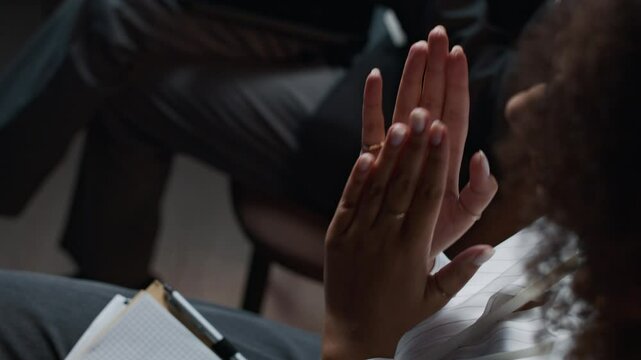 High angle view of unrecognizable young Black woman clapping hands at business conference