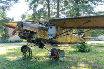 Old yellow airplane abandoned wreck in nature