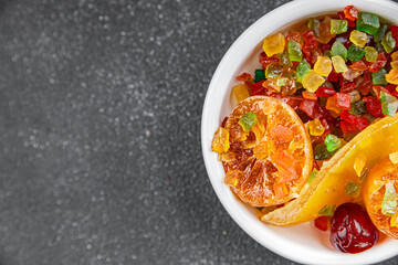 Candied peel and fruit orange, kumquat, tangerine, cherry, mango and others Sugar-coated fruit fresh tasty food dish delicious gourmet food background on the table rustic food top view copy space