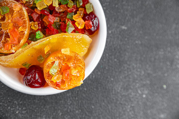 Candied peel and fruit orange, kumquat, tangerine, cherry, mango and others Sugar-coated fruit fresh tasty food dish delicious gourmet food background on the table rustic food top view copy space