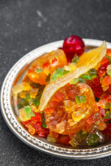 Candied peel and fruit orange, kumquat, tangerine, cherry, mango and others Sugar-coated fruit fresh tasty food dish delicious gourmet food background on the table rustic food top view copy space
