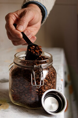 Scooping Coffee Beans from a Glass Jar