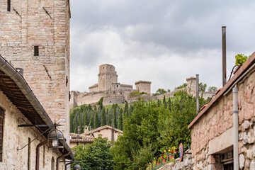 A castle with a large tower and a small tower in Assisi city in Italy Umbria