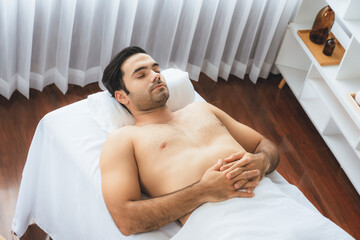 Caucasian man customer enjoying relaxing anti-stress spa massage and pampering with beauty skin...