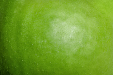Green apple texture as a background macro photo.