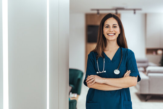 Confident Female Nurse Smiling in Hospital Wearing Scrubs and Stethoscope