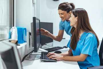Team of Nurses Collaborating at Computer in Modern Medical Work Environment
