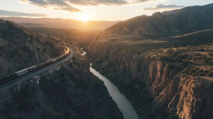 A train travels along a winding track through a canyon landscape