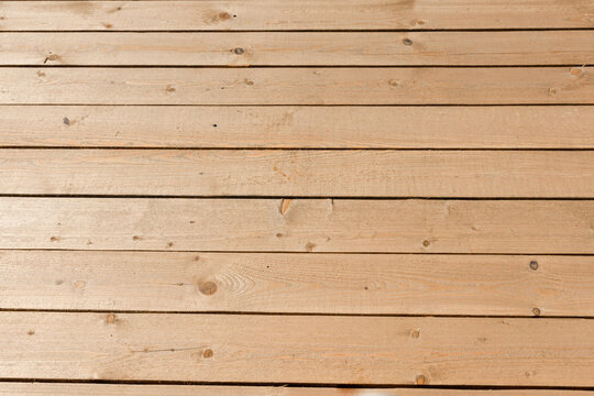 Temporary wooden flooring for moving around the territory. The flooring is made of untreated wooden planks on the street.