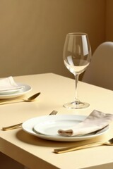 Minimalist table setup with clean glassware and utensils on a beige surface,, beige
