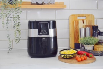 Black air fryer in the kitchen.  Healthy food preparation