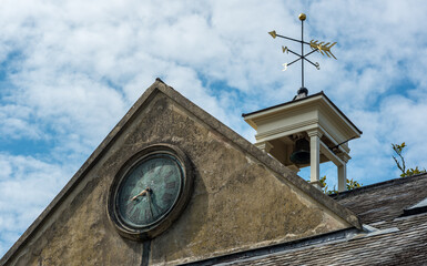 clock and weather vein on the roof