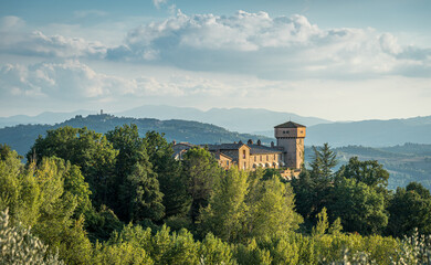 building on a hilltop with trees