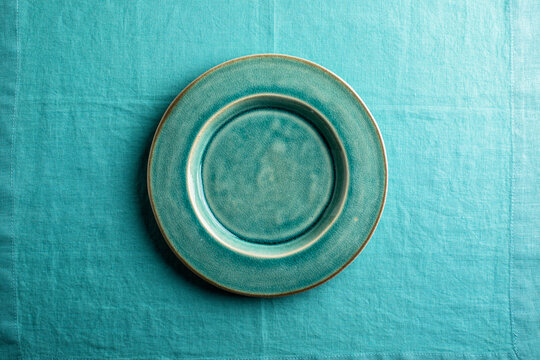 turquoise plate on aqua linen , overhead