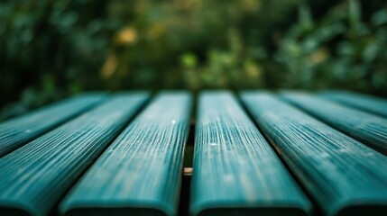 The close up of a green wooden table with the nature blurred
