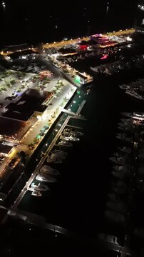 Cinematic aerial view from a drone at night on the Amador Causeway in Panama City, Vertical 4K Video