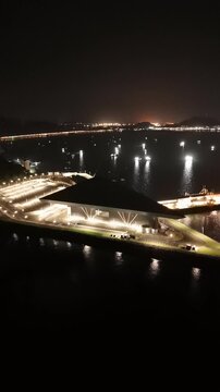 Cinematic aerial view from a drone at night on the Amador Causeway in Panama City, Vertical 4K Video