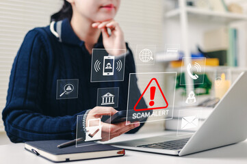 Scam alert warning. cybersecurity concept. Woman using laptop, warning sign for scams with icons representing online threats, phishing, and cybersecurity. Unknown person, suspicious scammer, fraud,