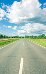 Long road with a few trees in the background