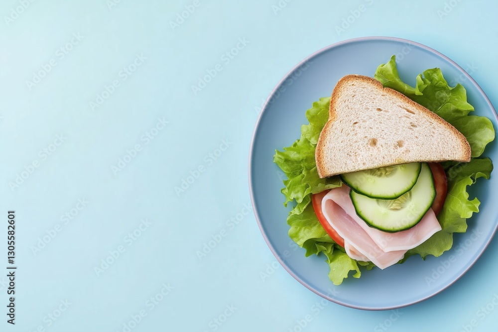 Poster a delicious sandwich with cucumbers and lettuce is placed on a blue plate. the plate is positioned o