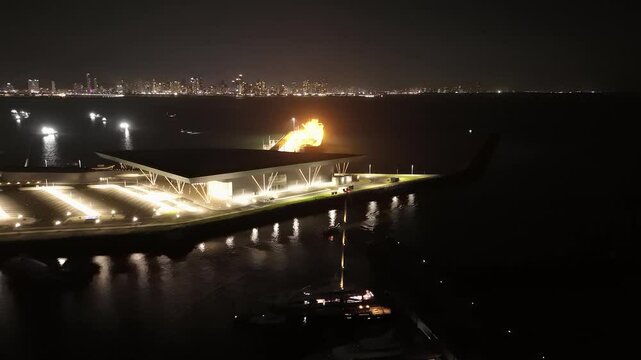 Cinematic aerial view from a drone at night on the Amador Causeway in Panama City, 4K Video