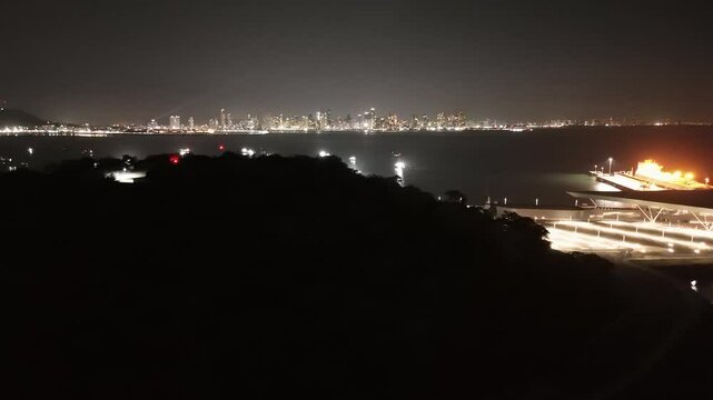 Cinematic aerial view from a drone at night on the Amador Causeway in Panama City, 4K Video