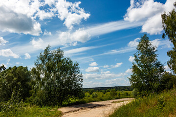 Countryside landscape with cirrus and cumulus clouds on blue sky